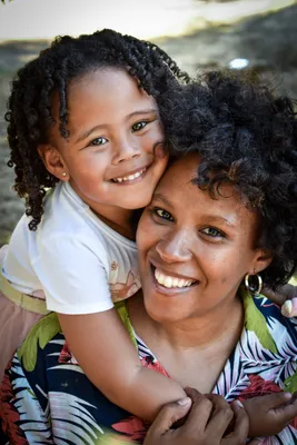 Child with parents. Child smiling while held upside-down.